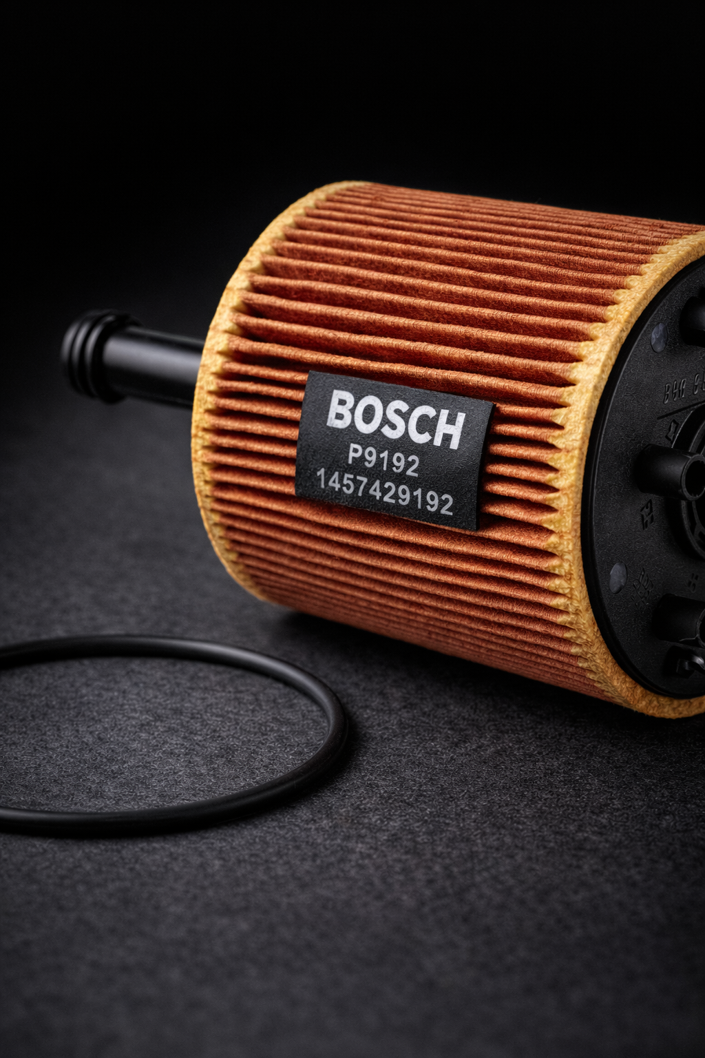 Bosch oil filter cartridge on dark background with sealing O-ring