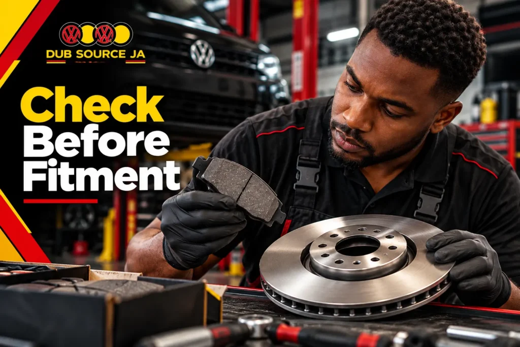 Mechanic checking replacement brake pads and discs before installation.